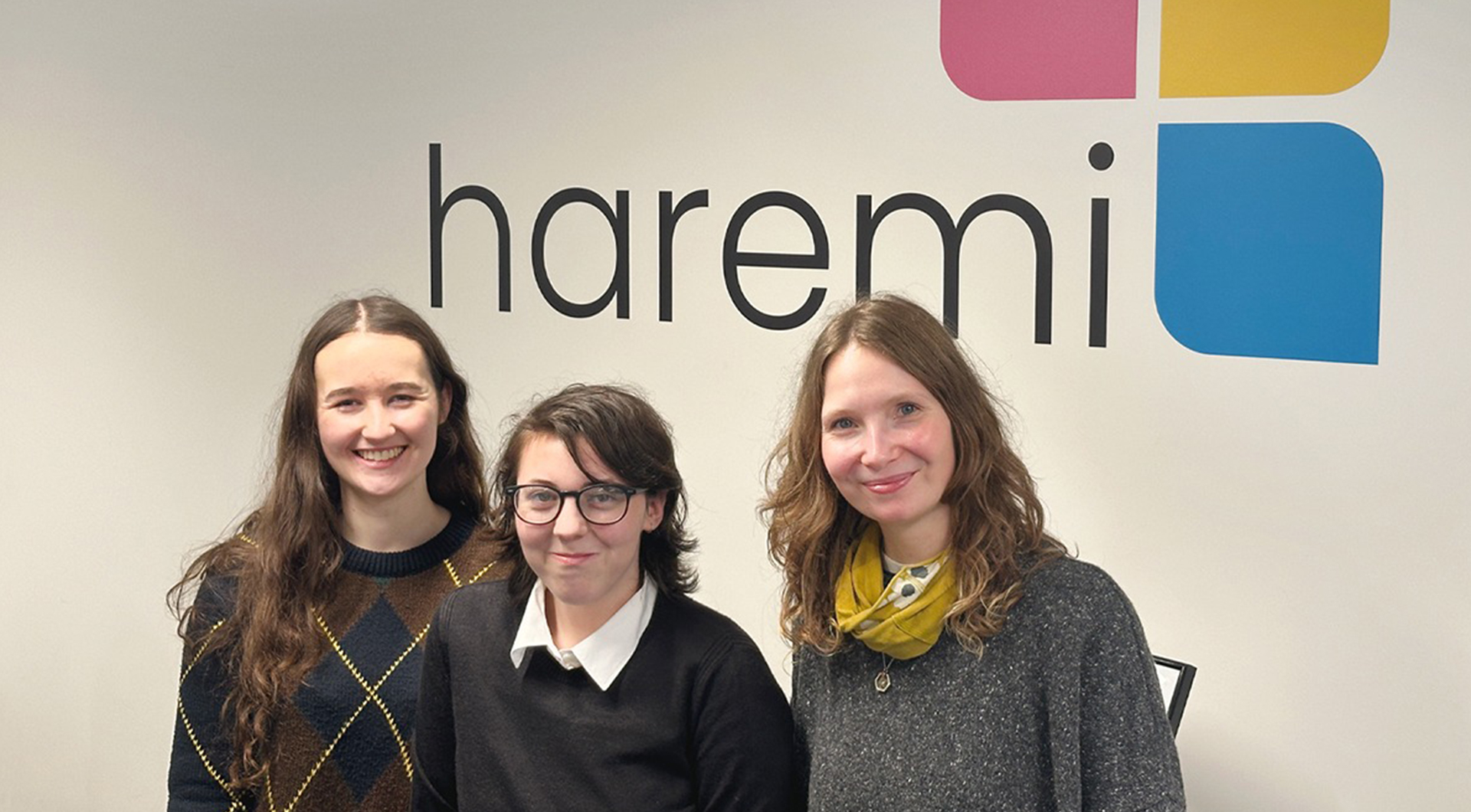 A person showing content on a tablet device to an older man wearing glasses.